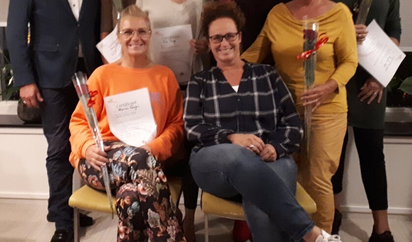 Coördinator Marieke Zwart (zittend in het midden) met een aantal vrijwilligers.