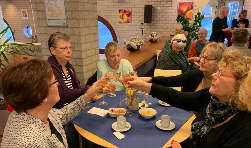 Vrijwilligers proosten met elkaar op het nieuwe jaar.