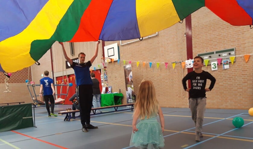 Kinderen vermaken zich in Sporthal Waldevaart met spel- en beweegonderdelen.