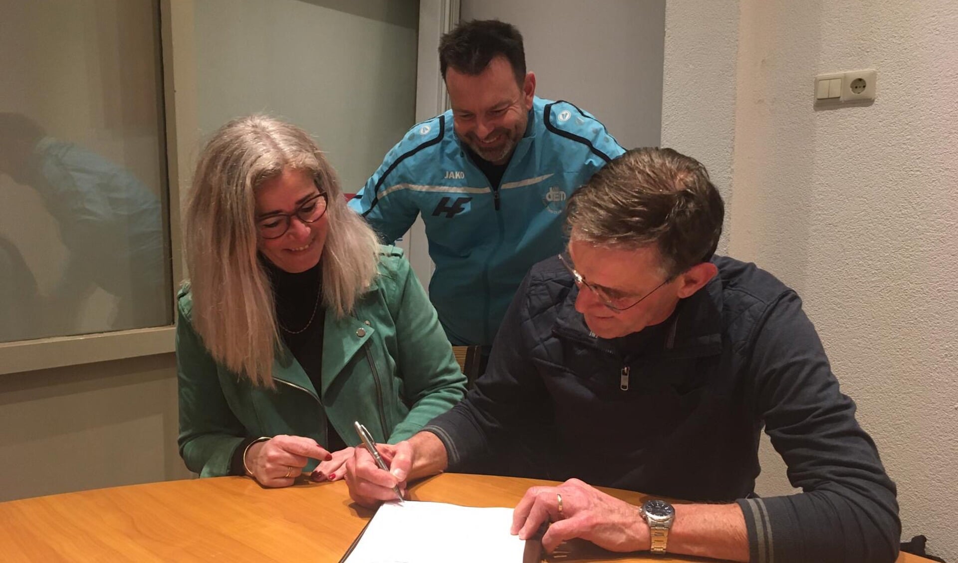 Voorzitter Karin Smit en penningmeester Jan van der Geest tekenen de overeenkomst onder toeziend oog van DEM-lid Bob Hofstede die betrokken was bij de voorbereidingen.