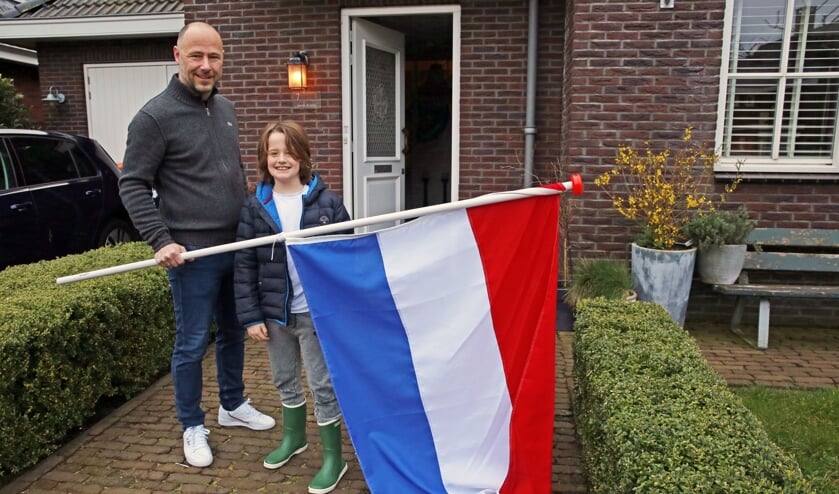 Stefan en zijn zoontje hingen vrijdagochtend de vlag uit als steunbetuiging.