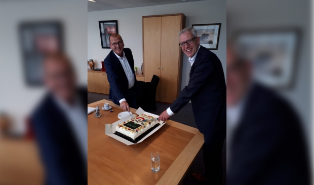 Het bezegelen van de samenwerking gebeurt door een taart aan te snijden.