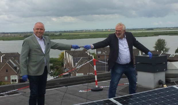 Jeroen Schalkwijk (Wormerland) en John van Nimwegen (WormerWonen) sluiten de 860 zonnepanelen aan.