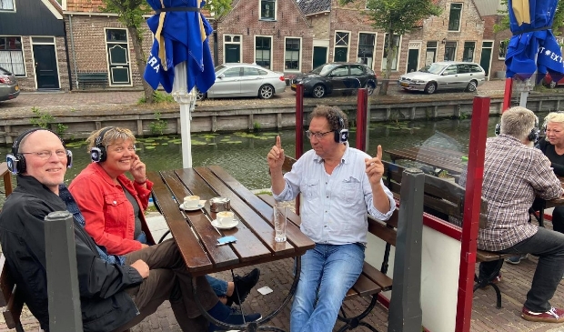 Siem-Kees Slegt geniet met de vingers omhoog op het terras van de muziek binnen