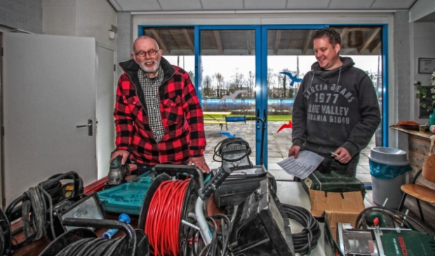 <p>Vrijwilligers Nico Molenaar (l) en Kjell van der Vlugt zijn druk bezig de elektrische apparatuur te keuren. </p>
