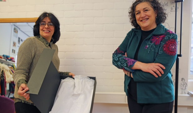 <p>Halleh Ghorashi (r) neemt het jasje in ontvangst van About a Jacket-deelnemer Heshmat Pourseif die het jasje genaaid heeft. Net als Halleh is Heshmat ook gevlucht uit Iran.</p>