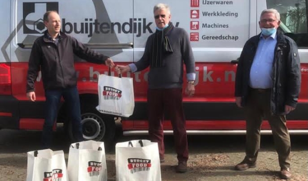 <p>Edwin Wilms en Willem Fritzemeijer van Rotary Club Den Helder overhandigen de pakketten symbolisch aan Nico Bais, voorzitter van de Helderse Voedselbank.</p>