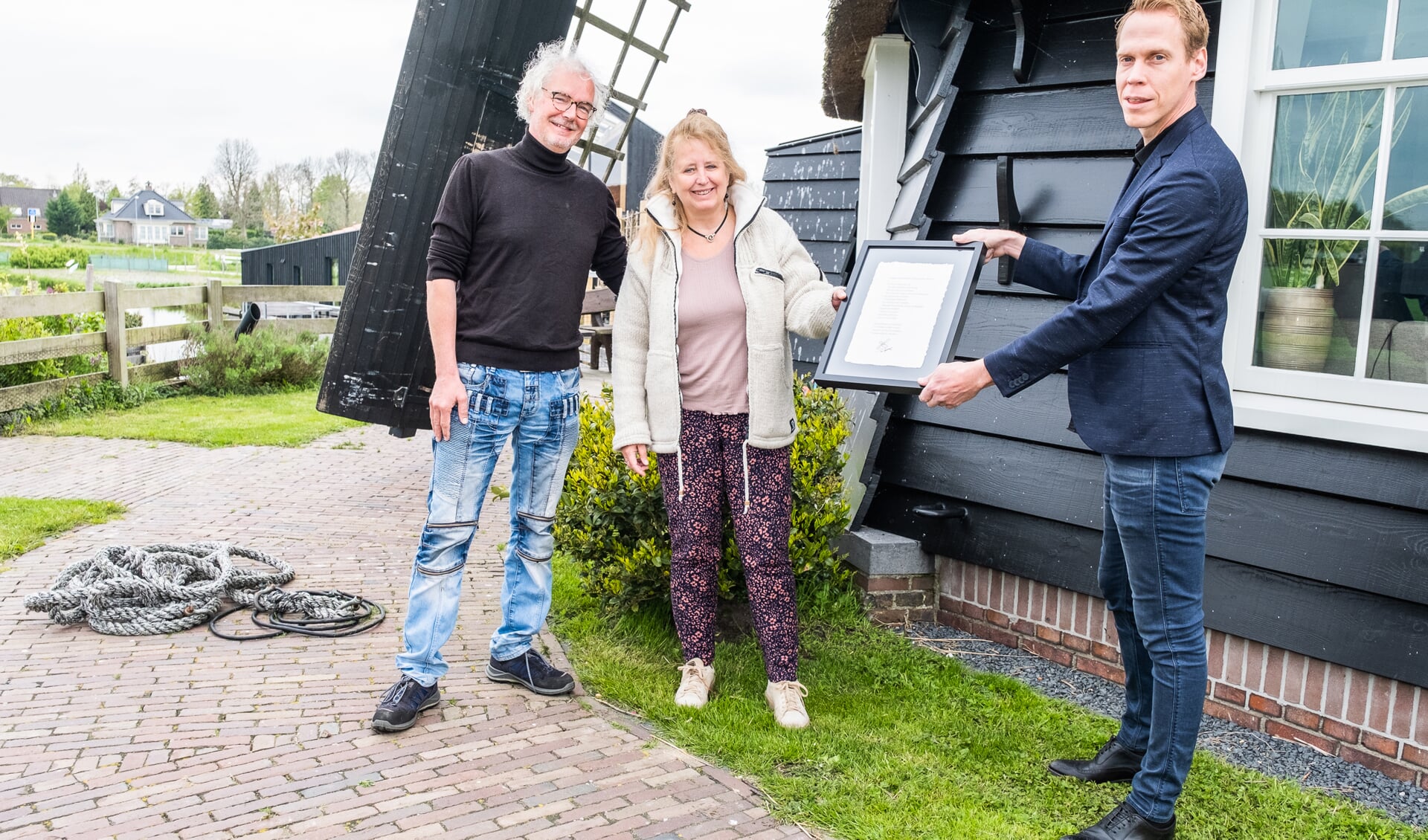 Uitreiking certificaat aan de molenaar Rob Basten en Suzanne Jong van de Twuijvermolen door wethouder Nils Langedijk van gemeente Langedijk.