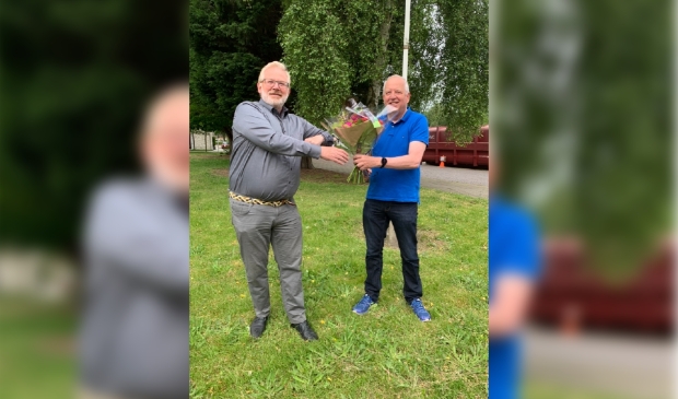 <p>Voorzitter Aalt Bruinekool (r) van CDA-Heemskerk zet John van Nimwegen in de bloemetjes op de dag na zijn verkiezing tot lijsttrekker.</p>