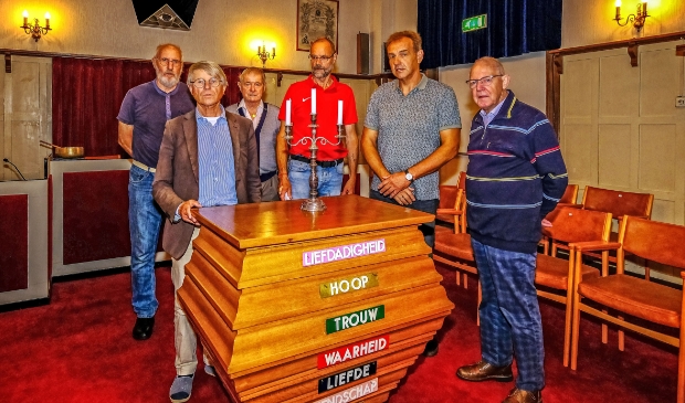 <p>Enkele leden en bestuursleden bij het altaar.</p>