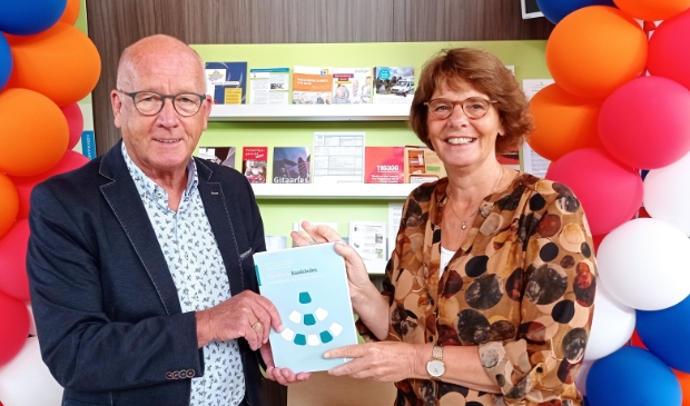 <p>Trudy Veninga overhandigt eerste exemplaar van de 'Bijbel' voor alle raadsleden.</p>
