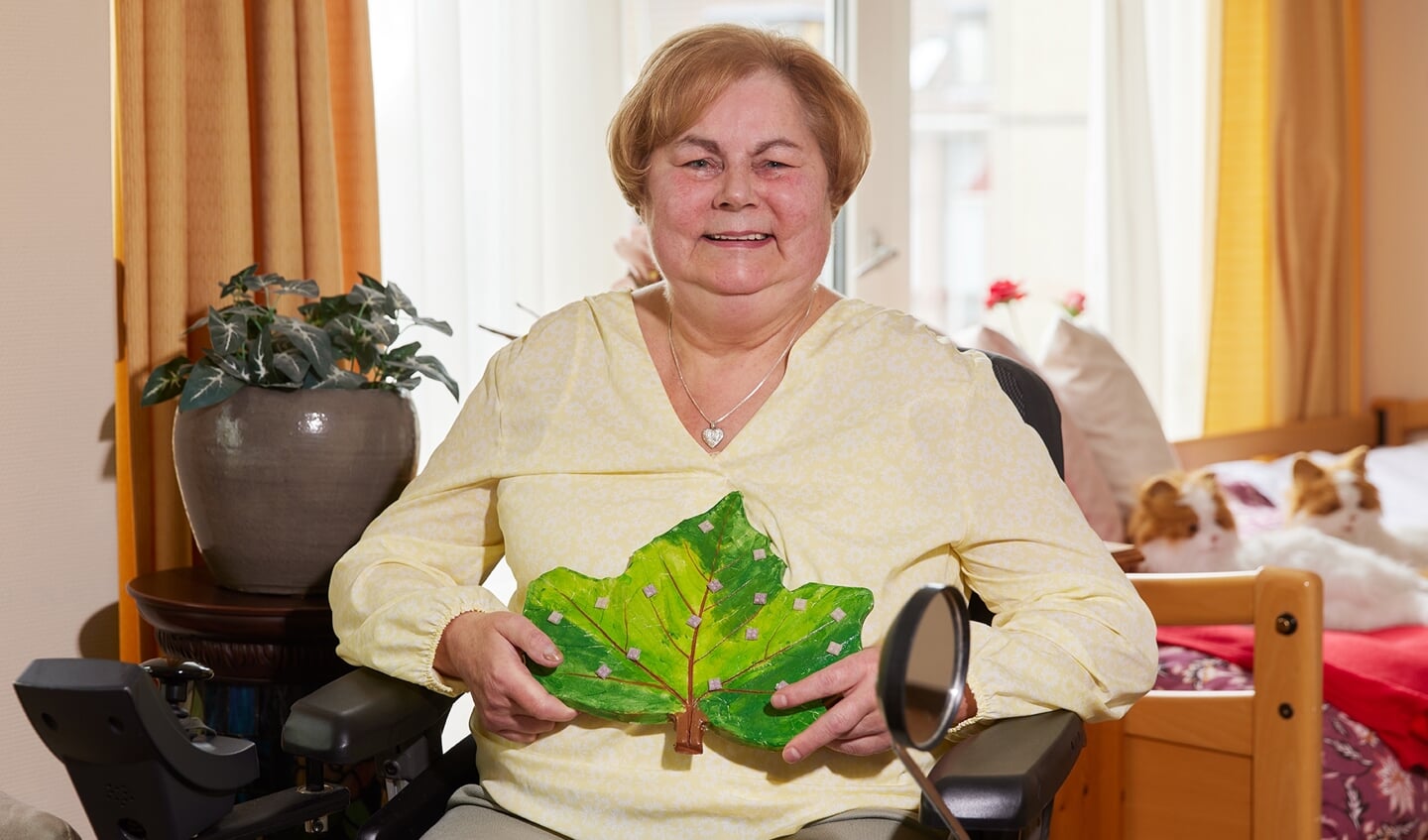 Carla Kostense (66 jaar) met haar kunstwerk Levensboom.