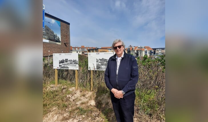 Jaap Stroomer bij enkele panelen van de fotoroute door het hele dorp. Op de achtergrond nog net hotel Prins Maurits te zien 