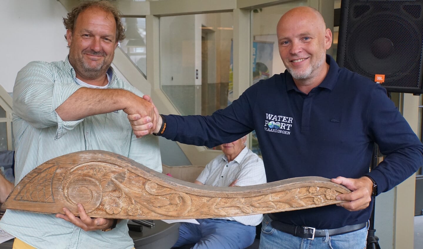 Coert de Heer (links) overhandigt tijdens het schippersdiner aan Olaf Hanno van de Waterpoort een helmstok om het roer van de Theodora te verfraaien.
