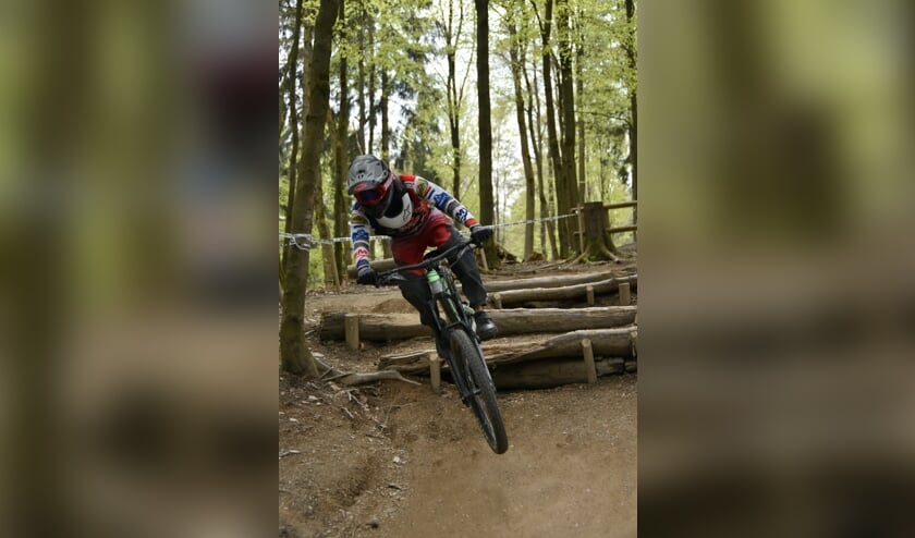Quinten springt met succes over een stapel boomstammen.