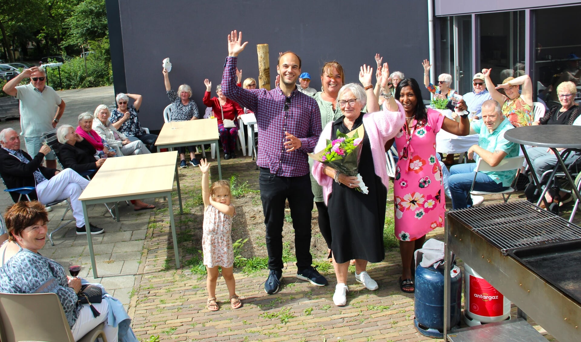 Wethouder Gijs van Malsen geeft bloemen aan Coby van Velzen. Met daarnaast wijkcoach Anita de Vriend en Madhu Jokhoe van Welzijn Rijswijk.