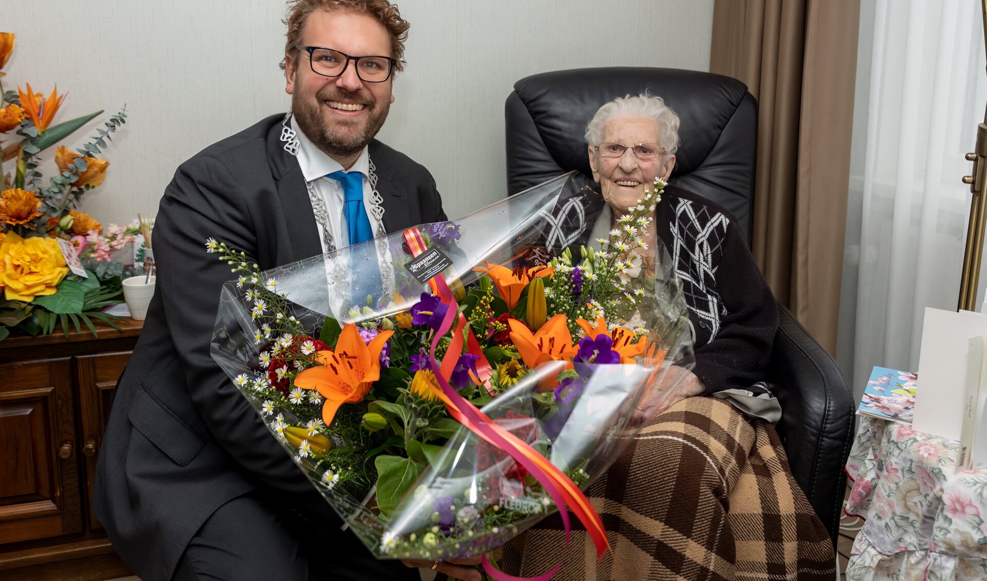 De jarige mevrouw Vonk werd in de bloemetjes gezet door burgemeester Poorter.
