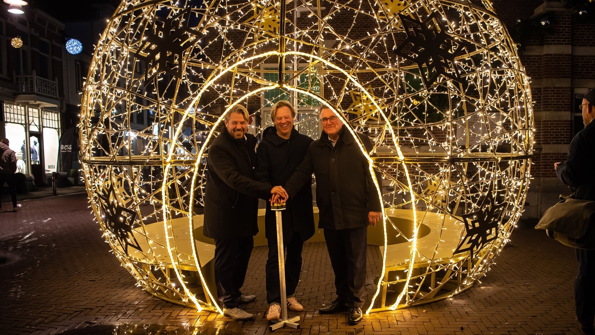 Wethouder Pascal Verkroost, BIZ-bestuurslid Renzo Leegwater en wethouder Mario Hegger ontsteken de eerste kerstbal.