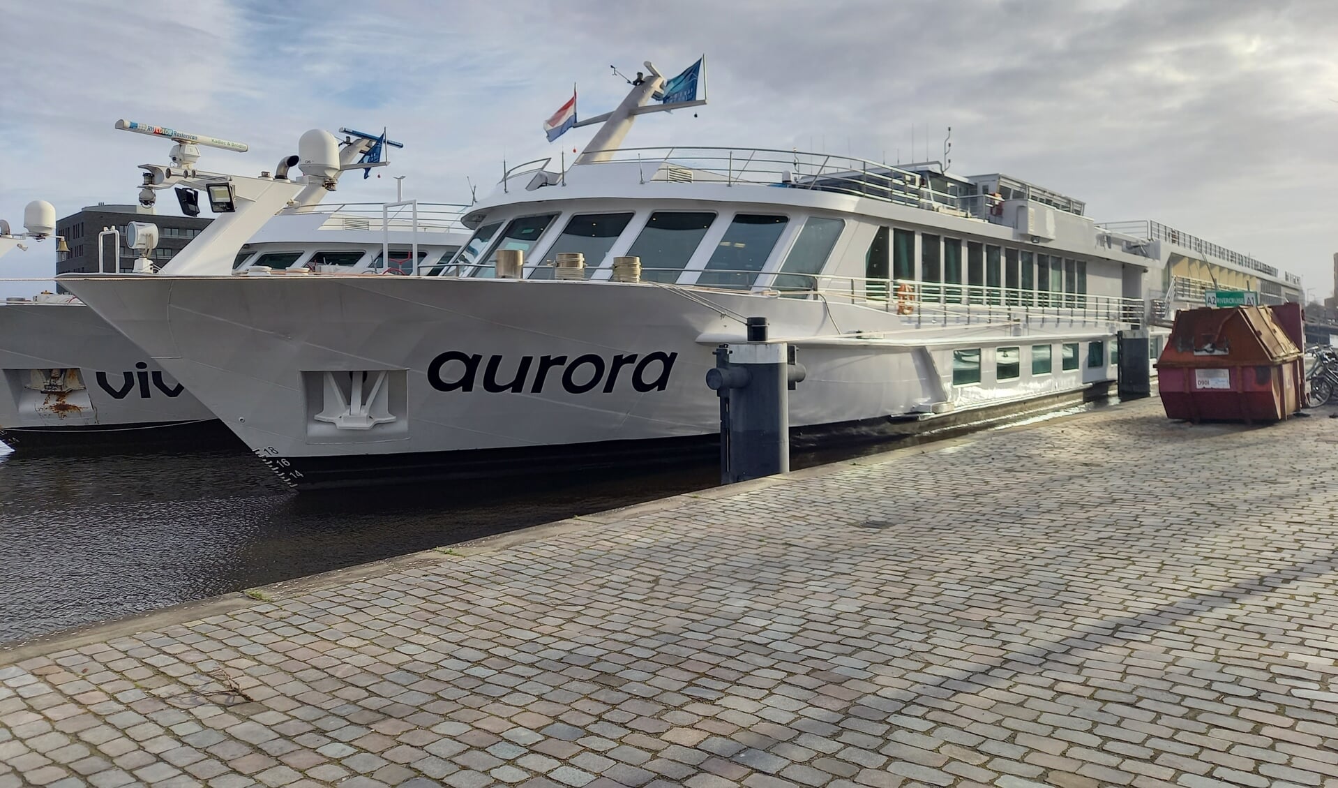 De MS Aurora wordt ondersteund door een tijdelijk schip dat is aangemeerd.