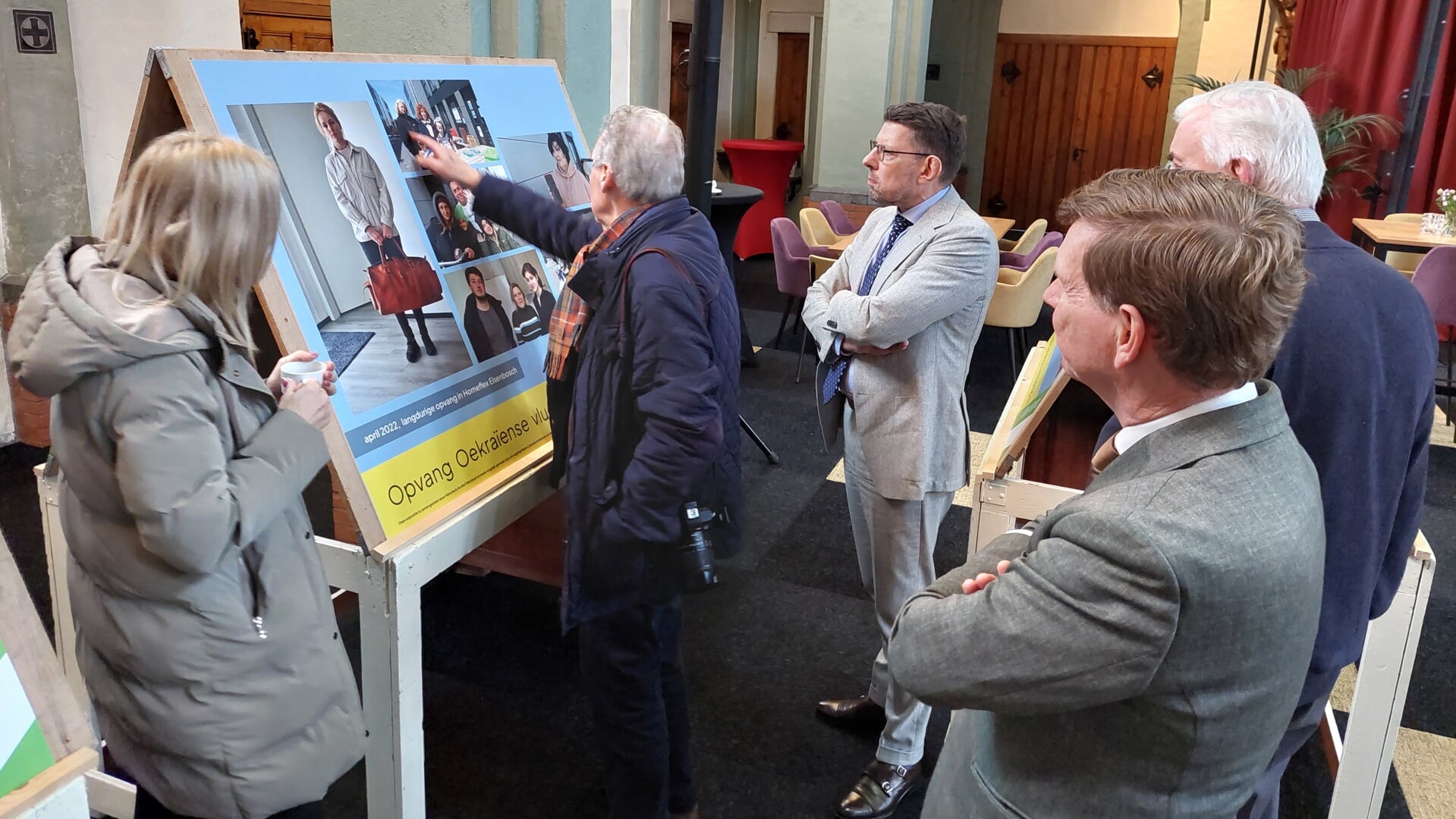 Burgemeester Bouke Arends bekijkt enkele foto's van de expositie.