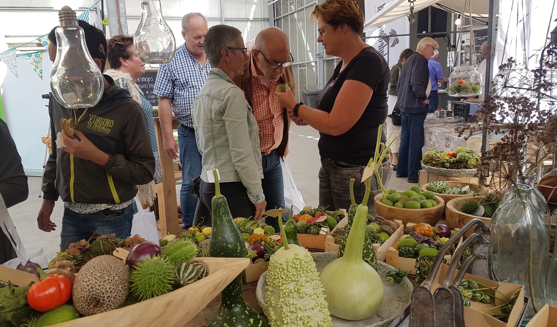 Afke Schrale van Bloeiers geeft uitleg over haar siervruchten op de Boerenversmarkt. (Foto: aangeleverd)
