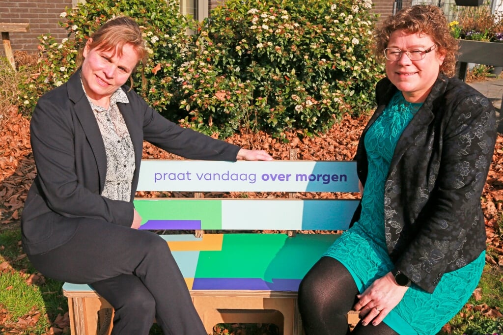 Gabriele Kasten van Pieter Raat (l) en wethouder Annette Groot praten op het 'Over morgen'-bankje over de toekomst van de ouderenzorg in Heerhugowaard.
