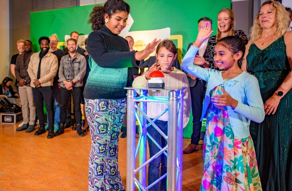 Met een druk op de knop lanceerden drie leerlingen van basisschool de Fontijn #HeelDenHaagLeest. De twee initiatiefnemers staan achter de kinderen.