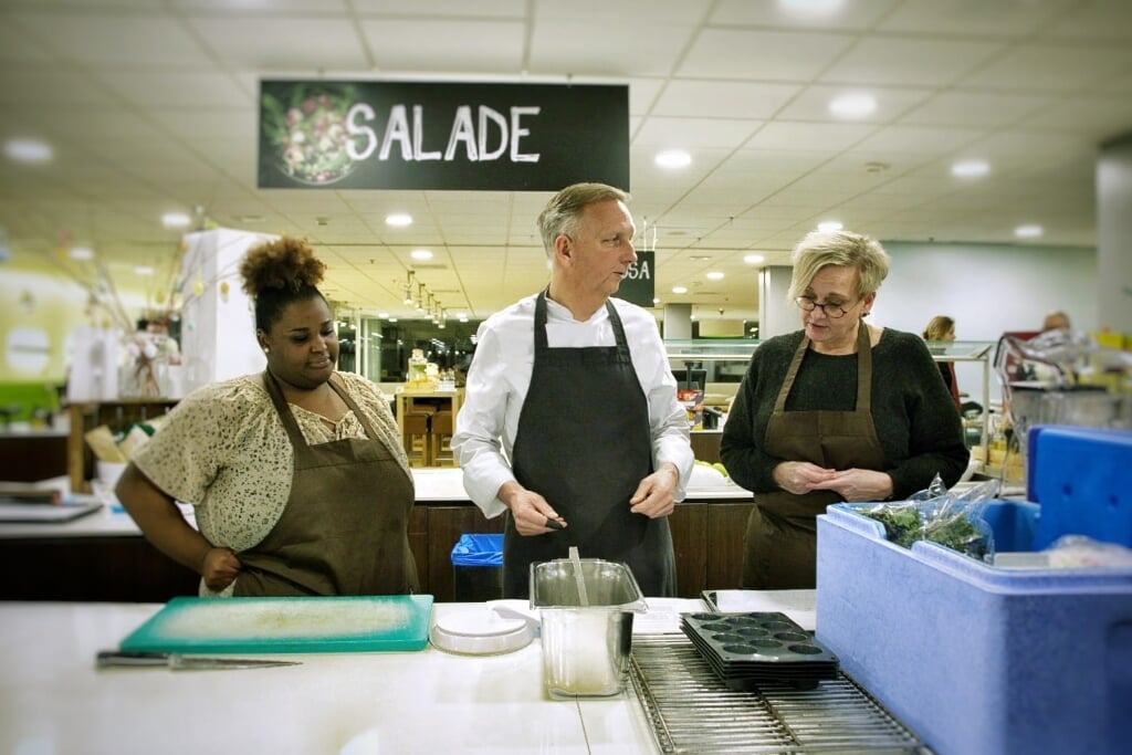 Serena van Engel, Chef-kok Karel van Tiel en Marianne Notenboom zijn bezig met koken.