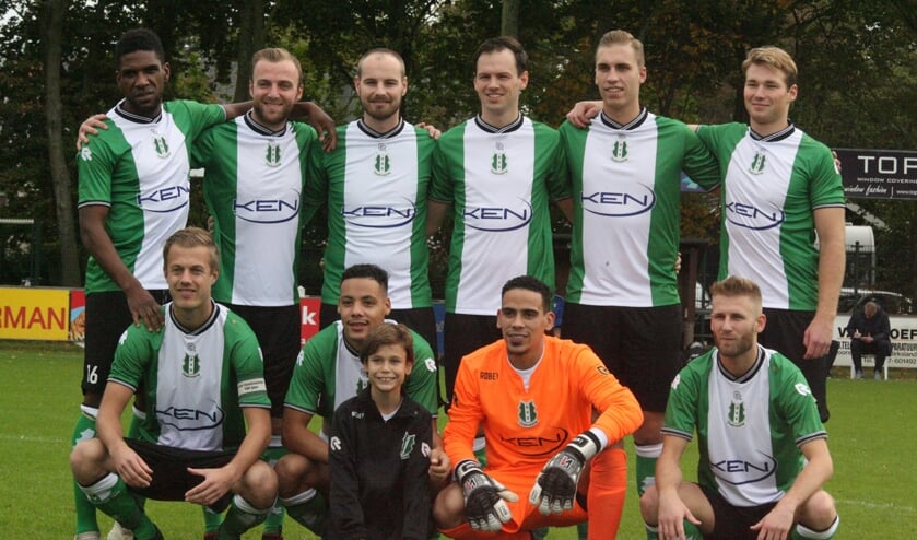 Het elftal van OVV ging graag op de foto met de pupil van de week. (Foto: Wil van Balen).