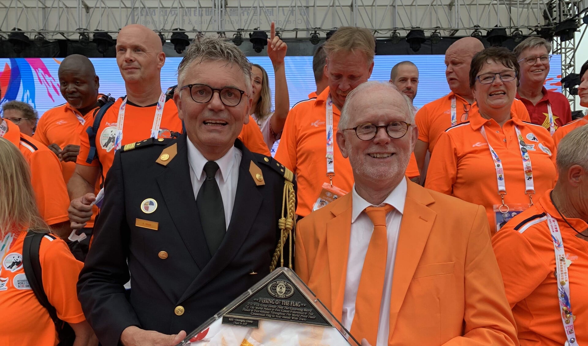 Arjen Littooij, Algemeen Directeur veiligheidsregio Rotterdam-Rijnmond en Bestuurslid WPFG Rotterdam 2021, krijgt de vlag overhandigd door Larry Collins, President WPFG Federation.