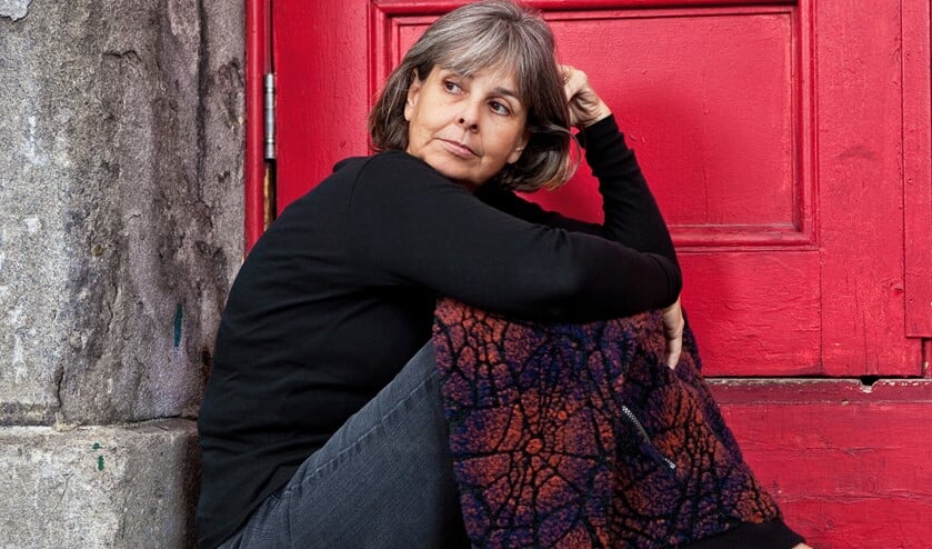 <p>Pensive woman sitting on door stoop</p>