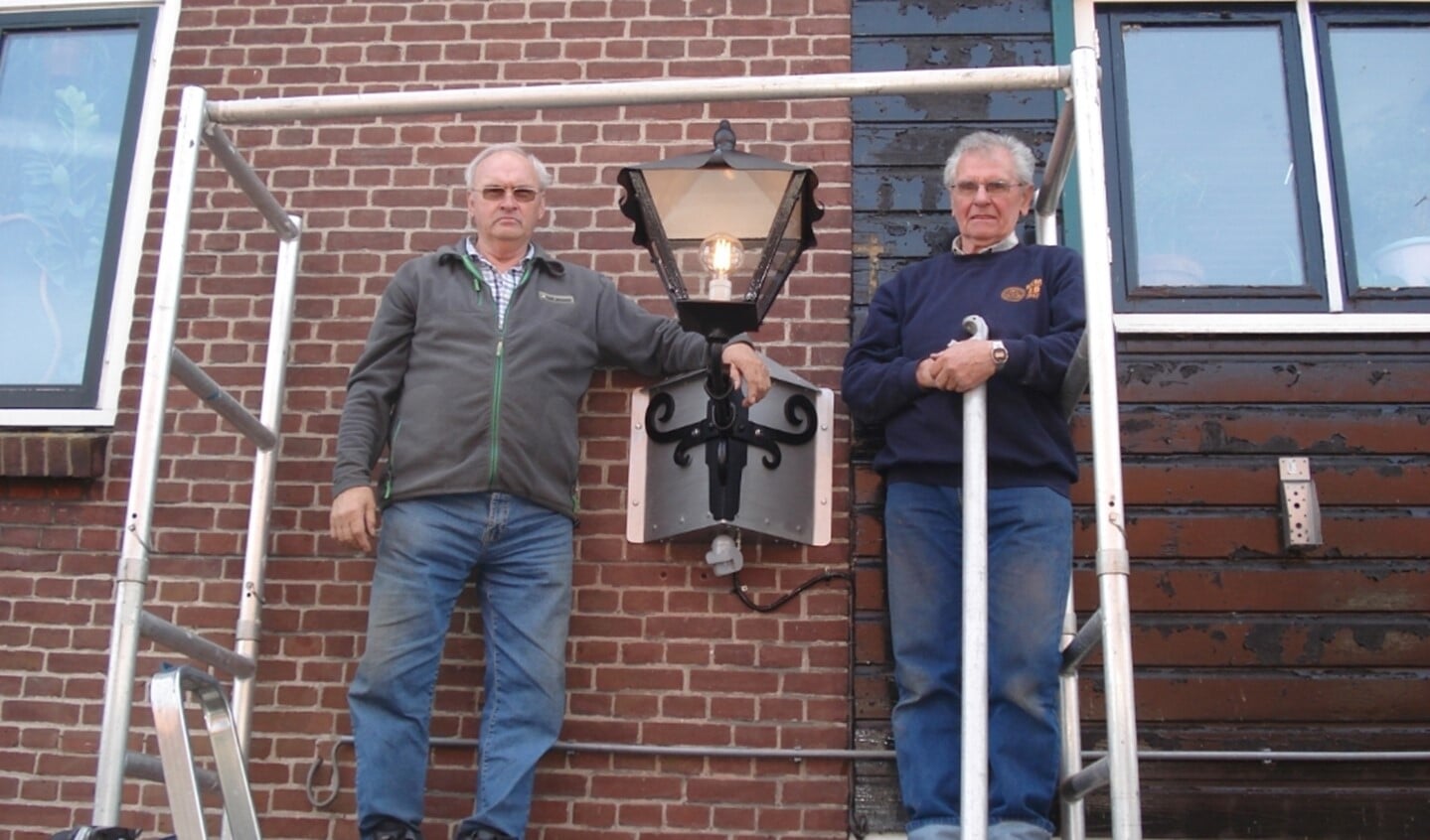 Hans Bijl en Teun Rookhuizen zorgden ervoor dat de lamp weer een mooi plekje kreeg. (foto: privé Jan de Koning)