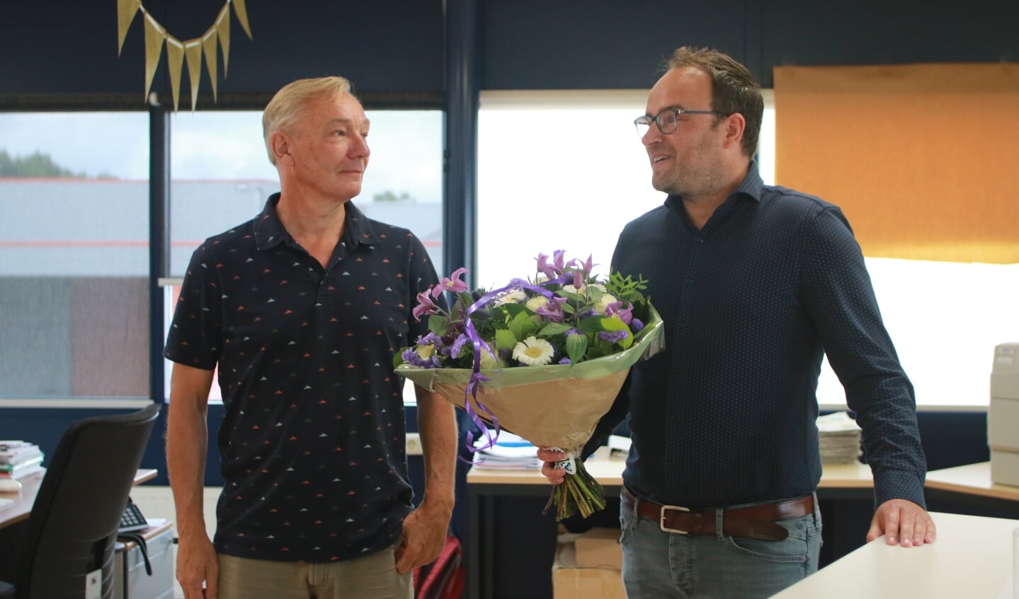 Bloemen, cadeaus en heel veel lovende woorden voor Henk de Baat (links) van Frank van der Sman. (foto: Wil van Balen)