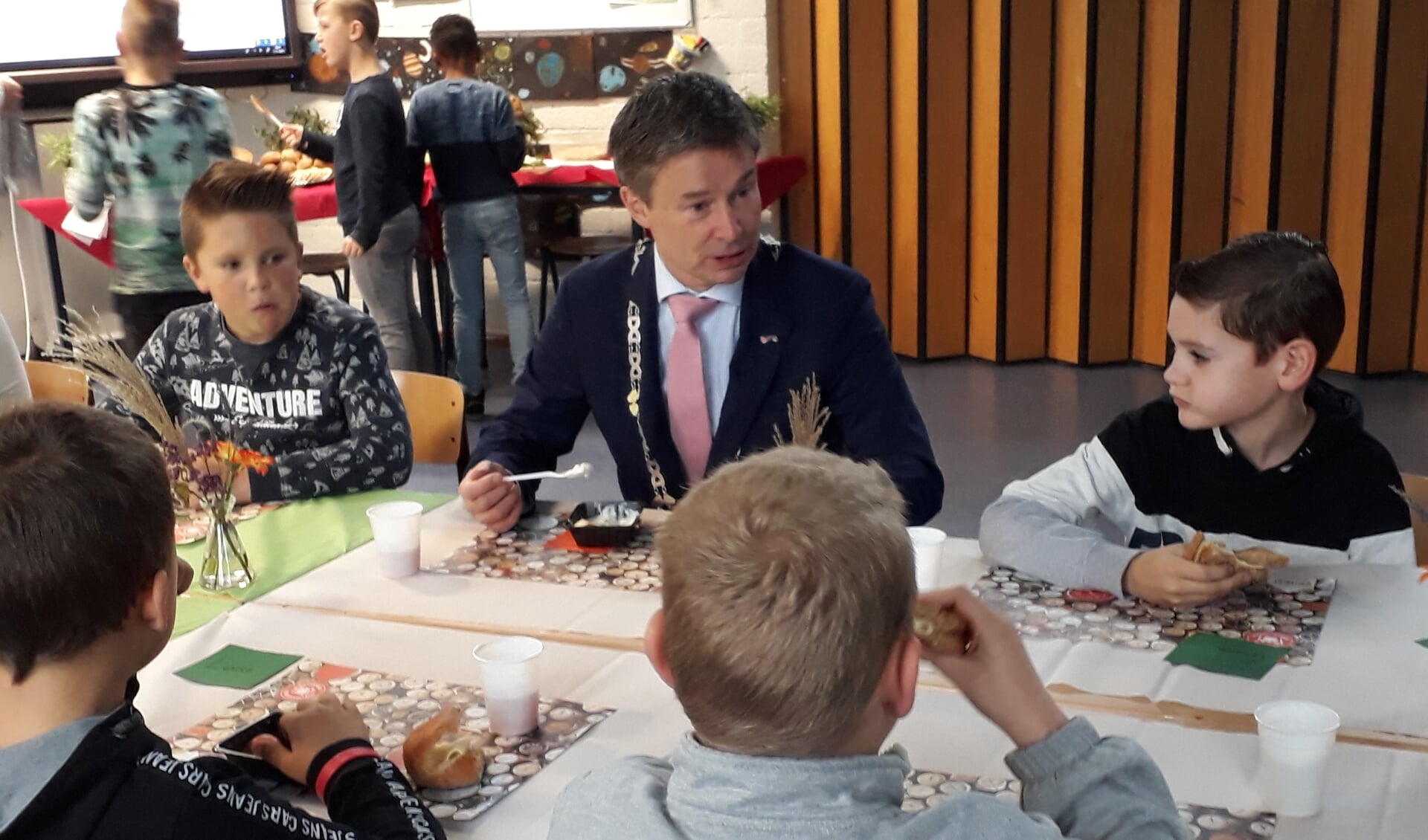 Leerlingen van De Hoeksteen eten en kletsen met burgemeester Hieltjes.