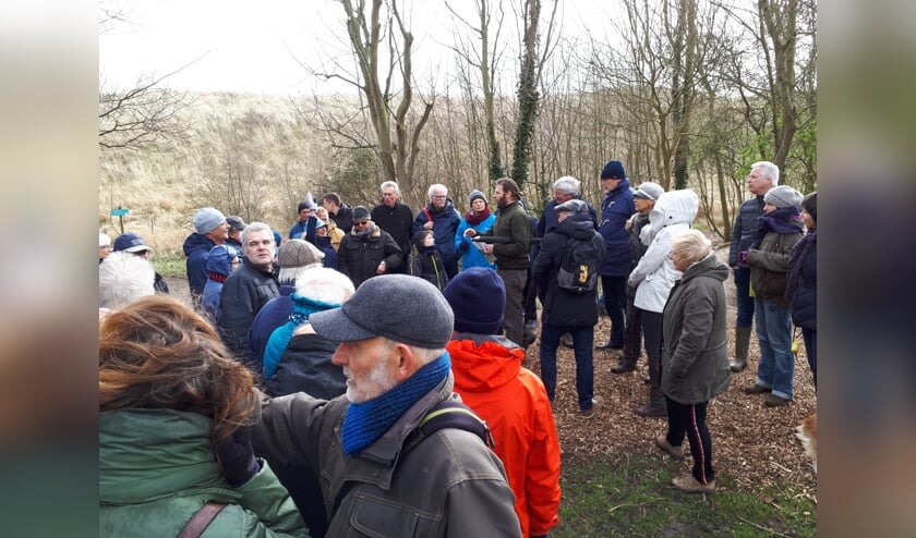 Landschapsarchitect Jan van Minnebruggen (middenachter met baard) vertelt de wandelaars dat hij hier een betere verbinding tussen Nollebos en boulevard voor zich ziet.