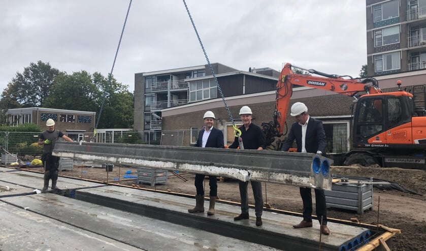 <p>Wethouder Paul de Beer legt samen met Cees van Boven en de producent de fundamenten van de twee flats</p>