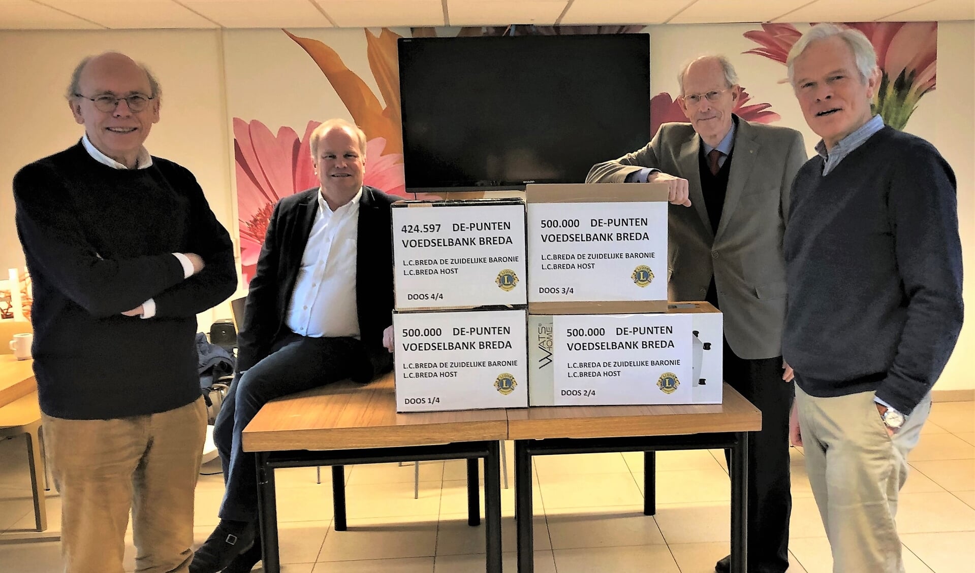 Overdracht van de DE-punten aan de Voedselbank. Op de foto 3 Lions en geheel rechts de heer Joost Bauwens, voorzitter van de Voedselbank.