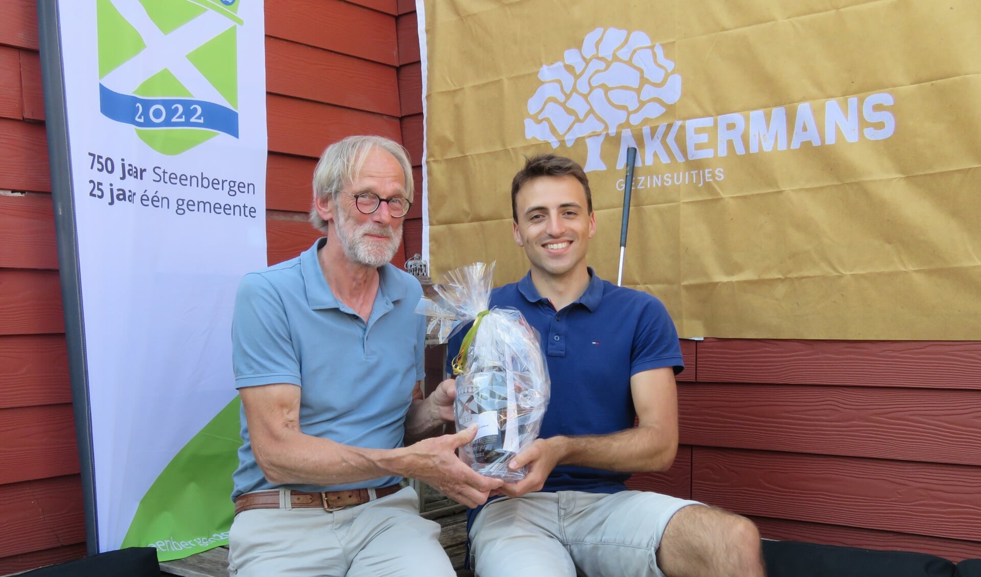 Organisator Jos Akkermans overhandigt Niels Ernest de 1e prijs van de golfwedstrijd 750 jaar Steenbergen.