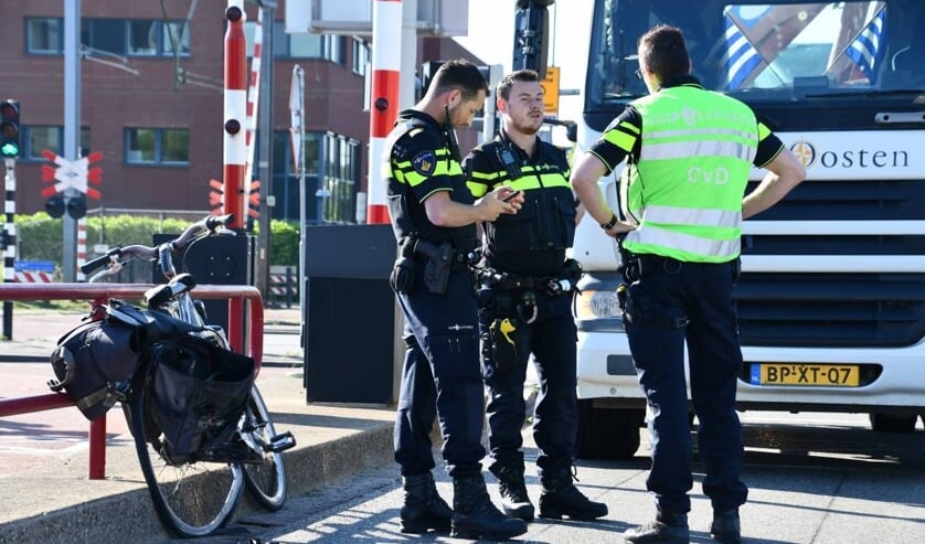 Politieagenten in overleg na het ongeval op de Schroebrug  