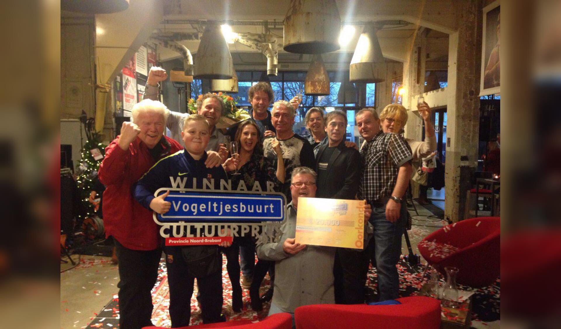 Pien Rosmalen, Peter van den Dungen en An van Dixhoorn samen met bewoners van de Vogeltjesbuurt met de prijs.