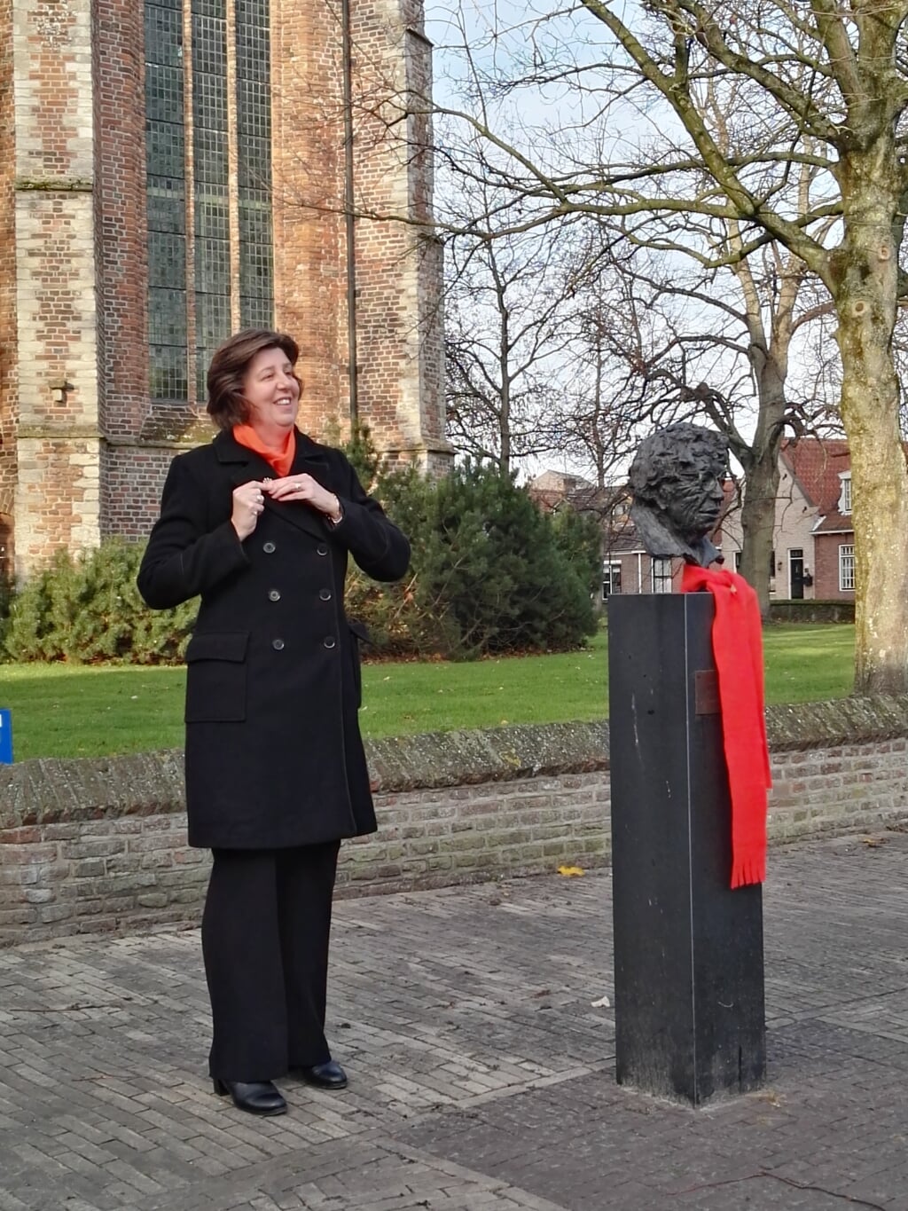 Wethouder Evertz van Gemeente Kapelle speldt het "Stop Geweld" handje op haar jas.