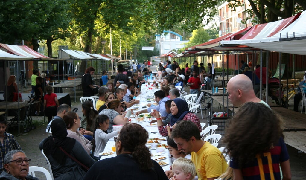 Tijdens de Burendag in september aten buurtgenoten met elkaar aan lange tafels. 