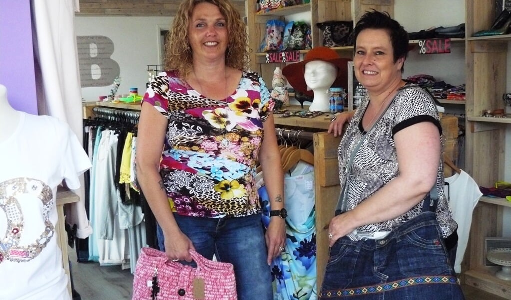 Arina en Belinda in hun winkel met enkele voorbeelden van zelfgemaakte tassen.