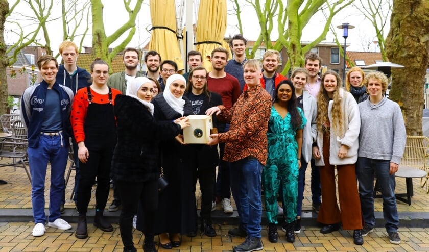 Sara Aljabi en Dima Akhras overhandigen de Doorkijker aan Kjeld Smit; Jippe van Niel en de rest van de steungroep kijken toe (foto: Koos Bommelé)