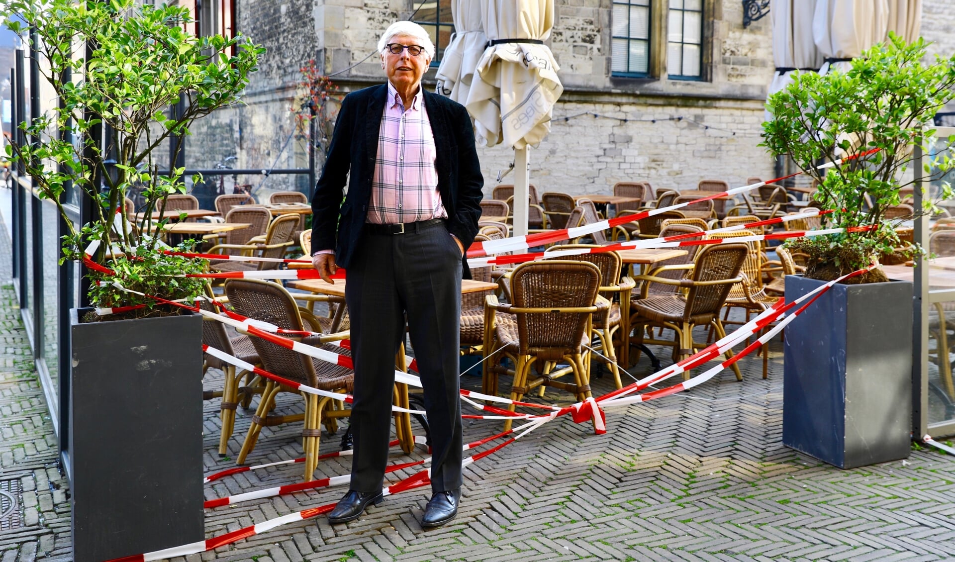 Leo Quack staat na een ochtend klussen voor het het lege terras van De Sjees, dat op 1 juni waarschijnlijk weer open mag. (foto: Koos Bommelé)