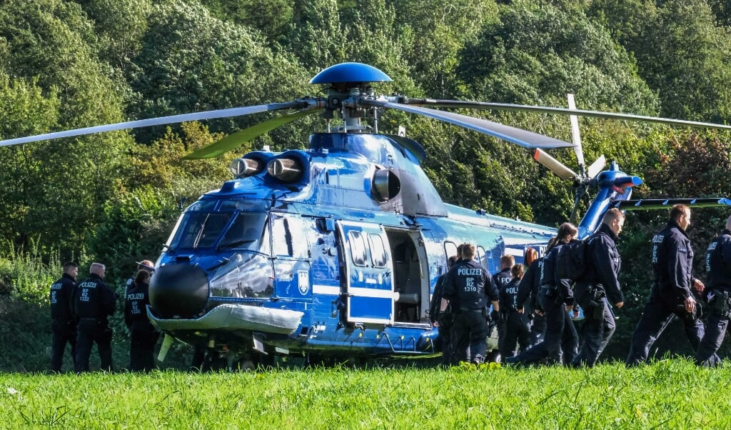 To helikoptere landede torsdag formiddag på en mark ved Oversø. 16 betjente sprang ud, løb over til vejen og stoppede straks de første biler.  ( Sebastian Iwersen)