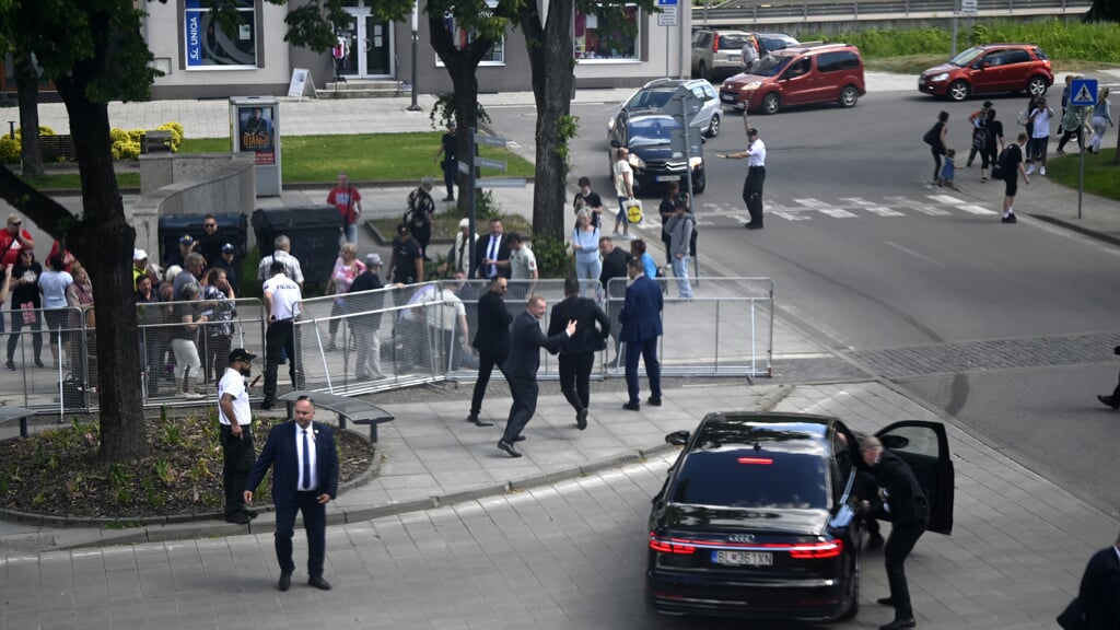 Ministerpræsident Robert Fico bliver efter attentatet bragt til en bil.  Foto: