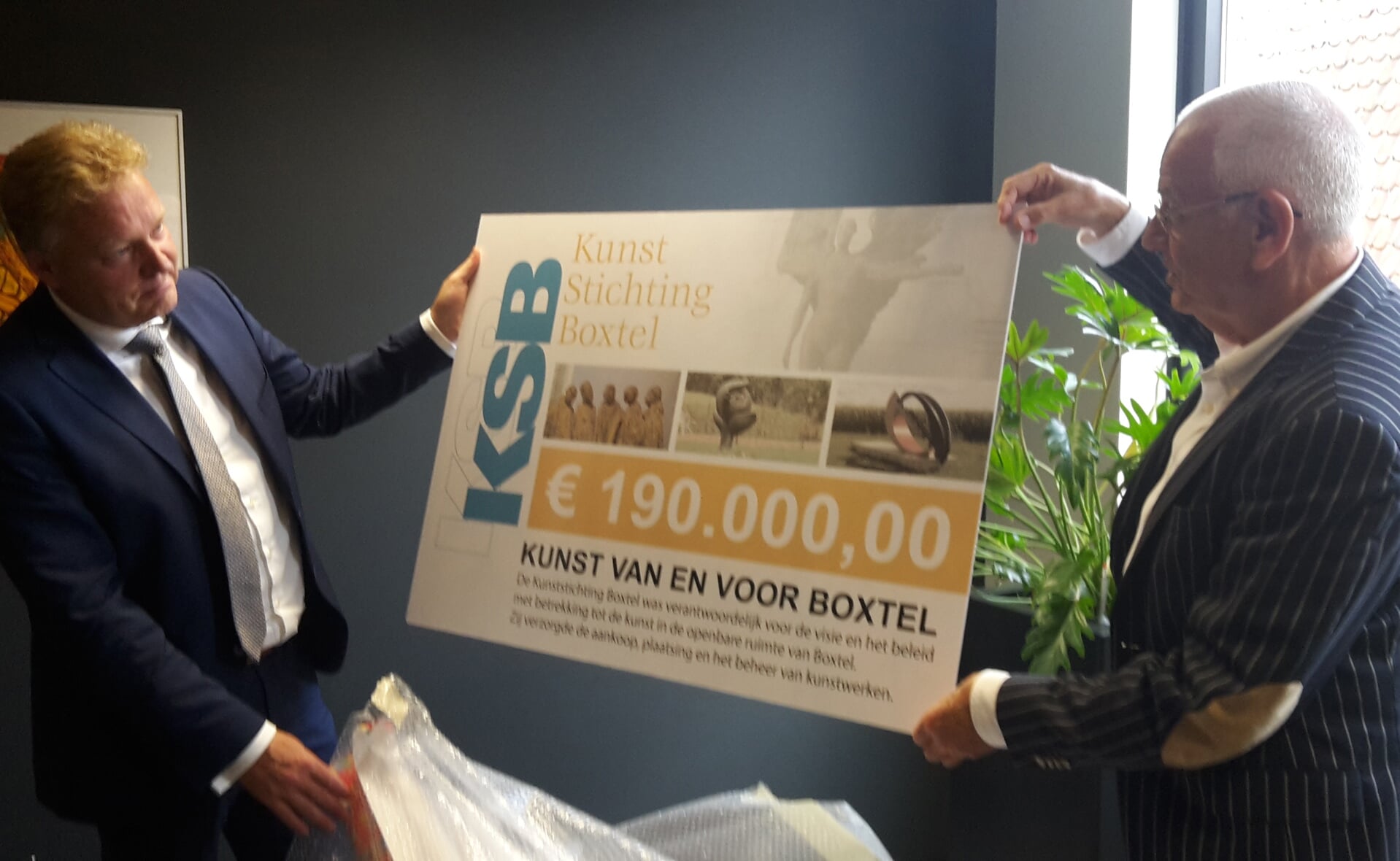 Voorzitter Gerard Schraverus (rechts) van de Kunst Stichting Boxtel overhandigde de cheque woensdagochtend aan burgemeester Mark Buijs. (Foto: Henk van Weert).