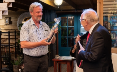 <p>Henk Renders (links) kreeg een flesje wijn van Maarten Roelofs Heyrmans die op zijn beurt weer het eerste boek in ontvangst nam. (Foto: Daisy Renders).</p>