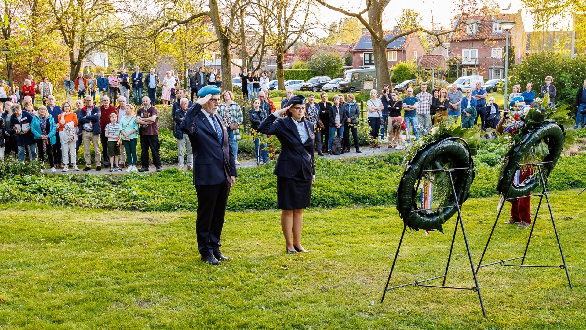 Theo Raaijmakers en voorzitter Jessie van Weert van Stichting Veteranen Boxtel brengen een saluut bij de kransen in processiepark Duinendaal.